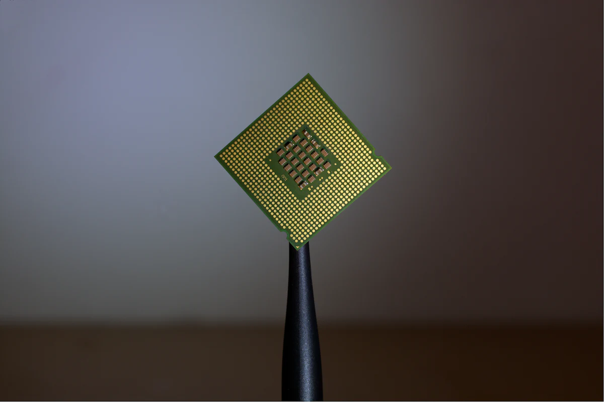 A processor held by tweezers ready for electrical test